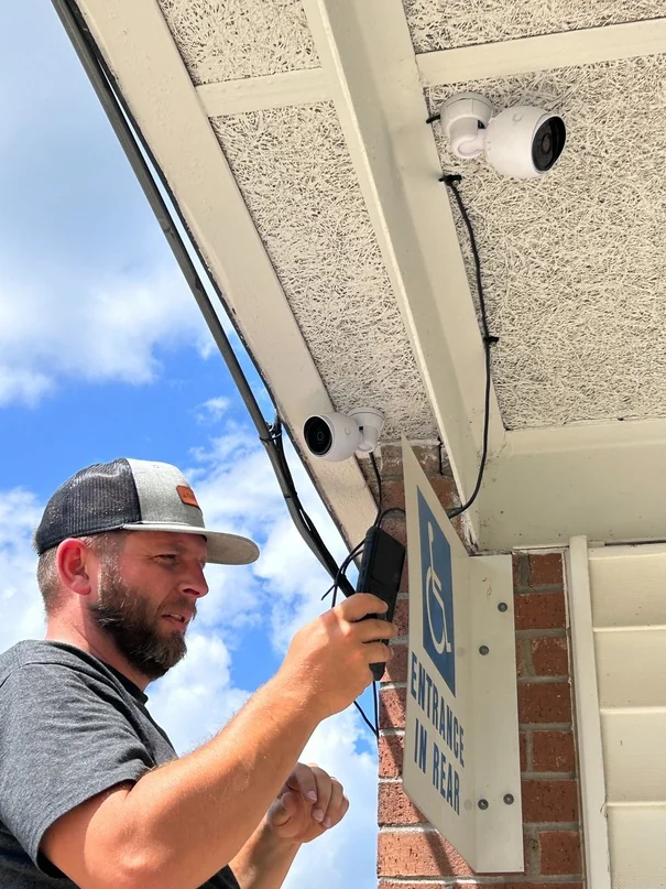 A Black Rock technician installing a security camera at London Township