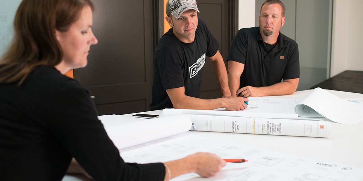 Employees looking over architectural plan