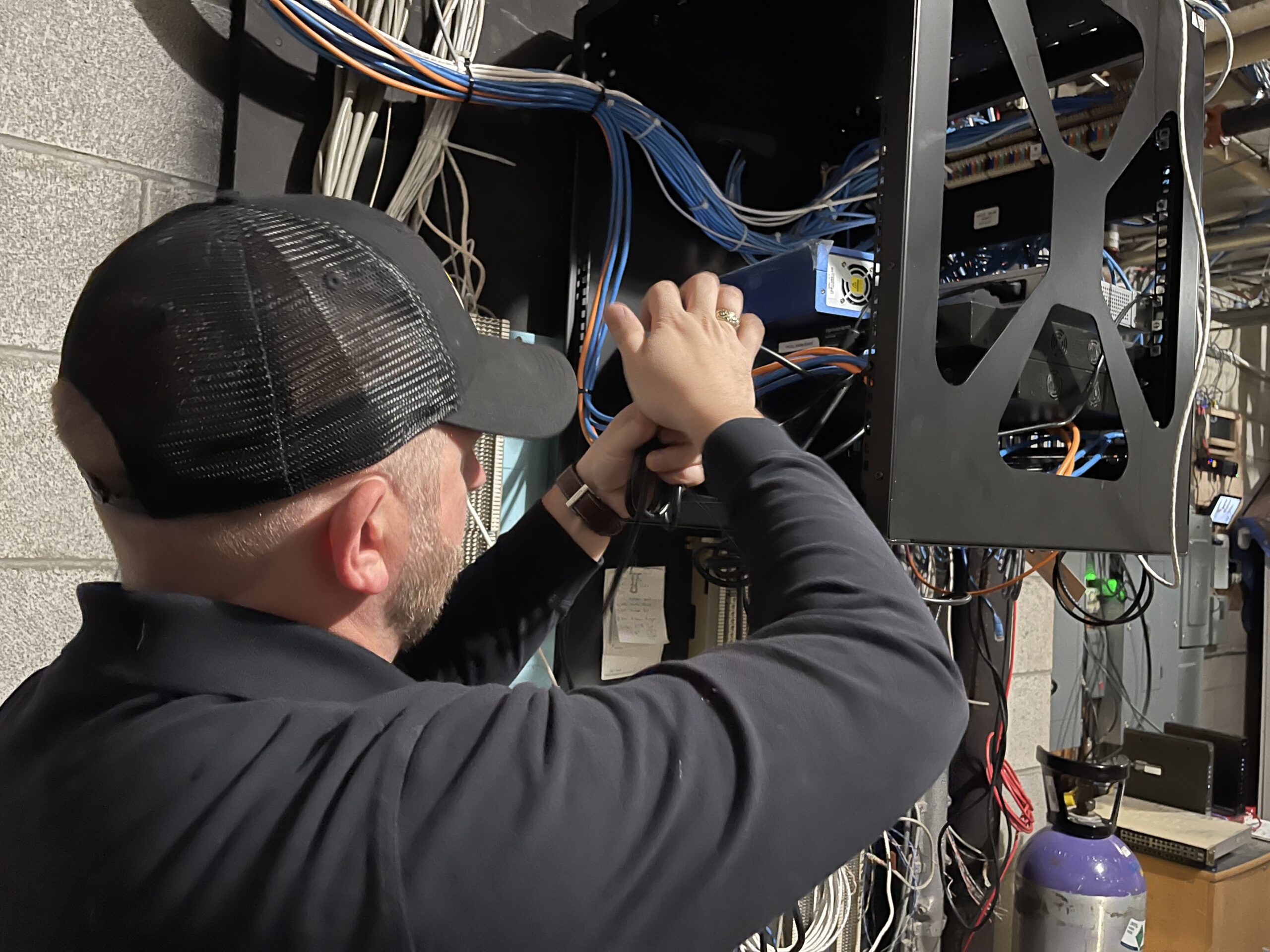 Black Rock Tech employee working on install of network equipment